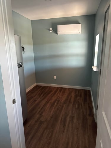 Small finished room with wood flooring.