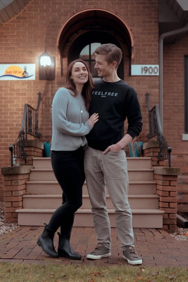 South Cliff Inn innkeepers, Daniel and Allison, in front of their inn before it was painted