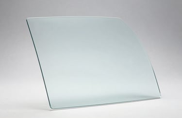 Studio photograph of a high-quality, tempered auto glass panel with smooth edges, reflecting soft blue and white light, emphasizing transparency and quality.