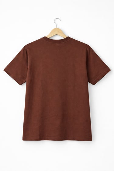 Back view of a plain brown cotton t-shirt hanging on a wooden hanger against a white background.