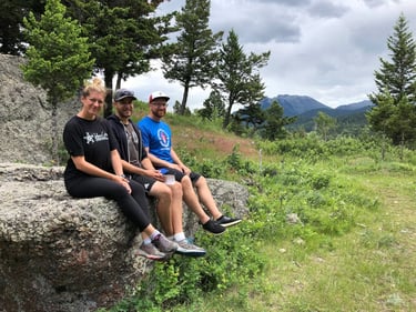 Family on rocks, hiking tour in waterton park