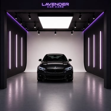A black luxury sedan inside a Lavender Car Care detailing studio with purple neon lighting.