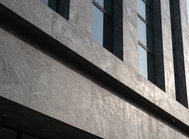 An elegant architectural detail of a premium business center in Dubai, showing strong slate grey lines and sophisticated design.
