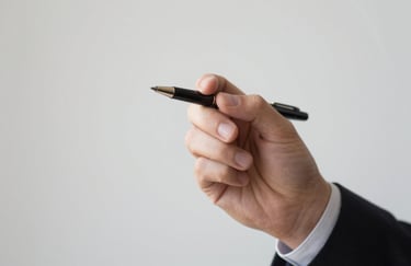 A close-up of a professional person's hand using a high-quality pen, symbolic of making empowered financial decisions, minimalist composition.