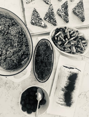 Flat lay of gourmet dishes including risotto, salad, and appetizers served on a marble countertop.