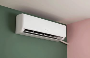 A sleek, wall-mounted air conditioning unit in a contemporary South American / Brazilian apartment. The room is decorated in a minimalist style with Forest Green and Soft Rose Pink highlights. Clean, professional photography.