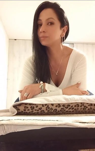 Primer plano de la masajista Avril apoyada en la camilla de su gabinete de relax en Almagro.