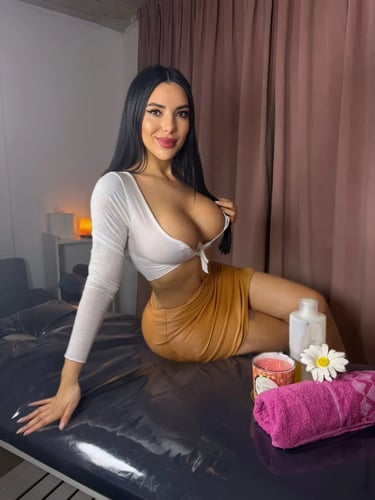 Florencia sentada con su crop top blanco y minifalda camel sobre la camilla negra en Palermo.