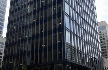 Modern North American corporate lobby with clean lines, glass walls, and a professional atmosphere in dark navy tones.
