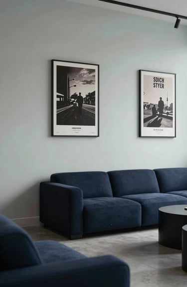 A sleek, minimalist lounge area for creators with Midnight Navy furniture and Pale Mist walls decorated with film posters.