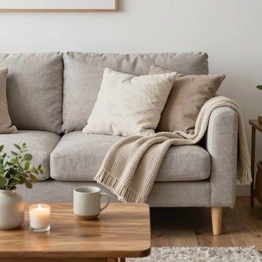 white and brown ceramic mug beside clear glass bottle