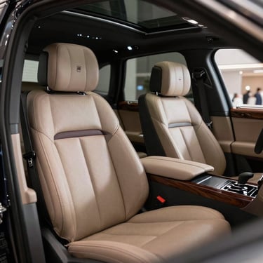The interior of a bespoke luxury vehicle featuring hand-stitched leather and dark wood trim, soft ambient lighting, North American / European Luxury Automotive Market.