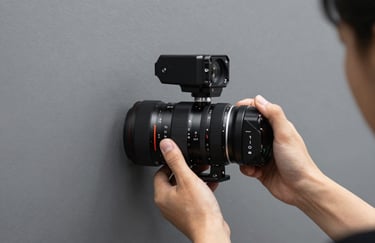 A person using a professional level on a modern grey wall, focusing on precision and craftsmanship, minimalist colors.