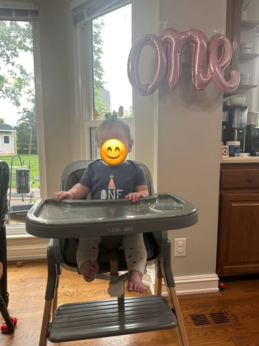Celebrating babies 1st birthday in easy to clean high chair