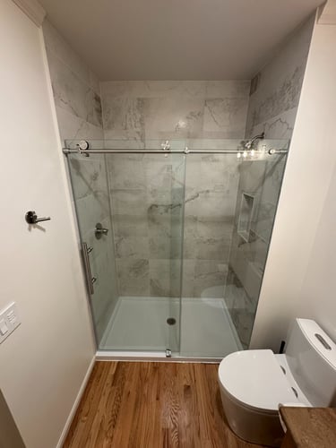 Shower Glass Installation on Modern bathroom renovation new custom tile and fiberglass pan Snohomish