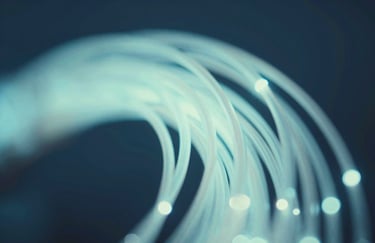 Abstract visualization of data flowing through fiber optic cables, glowing with #ADC8CD tones against a deep #0A192F background, representing high-speed connectivity.