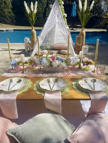 Styled elevated gathering with teepee, layered florals, plush seating Gathered Grace Picnic Co.