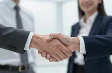 Close up of a professional handshake between two partners, highlighting a spirit of collaboration and trust, with a bright, clean office background.