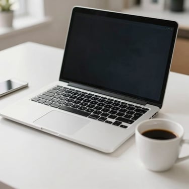 A close-up of a modern laptop and a cup of coffee on a clean, white desk in a bright North American home office setting.