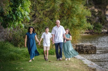 A Family of four walking along the foreshore Minim Cove by Fisher Photography