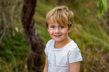Young boy smiling in natural light outdoor portrait in Perth bush setting, Fisher Photography Perth