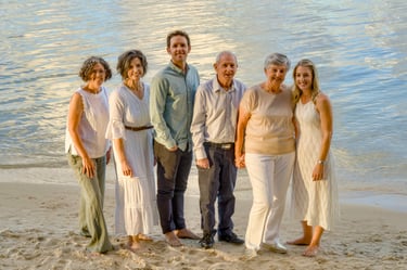 A family of six including four grown up children standing in front of The Swan River at Point Walter