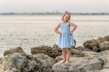 Girl standing on limestone rocks at Point Walter, Attadale, at dusk, Perth family photographer Fisher Photography