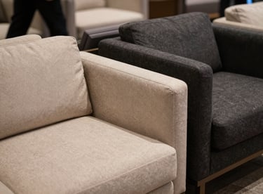 Detail of an elegant lounge area at a high-end event featuring modern furniture in soft beige and dark charcoal.