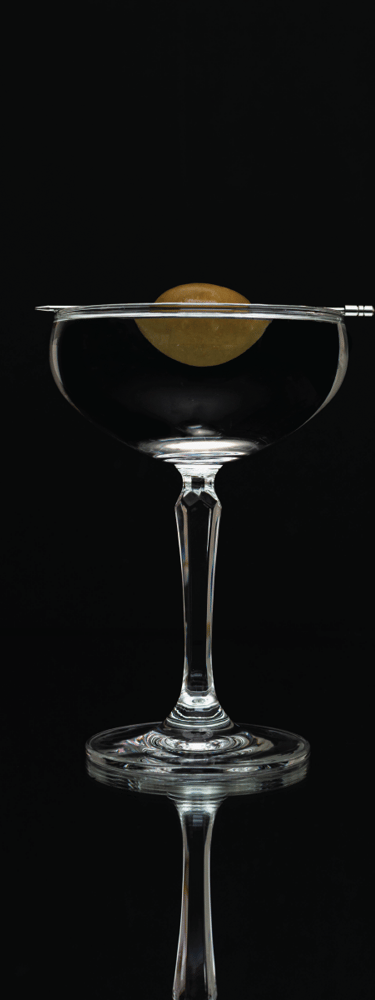 a martini glass with a olive on it