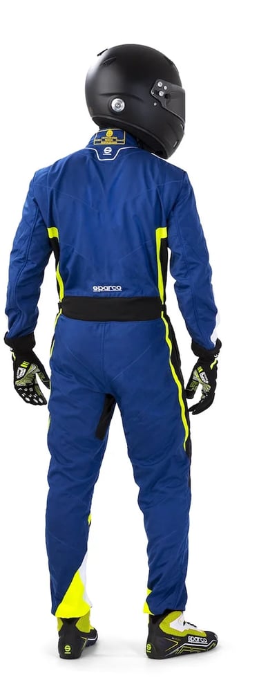 Rear view of a driver wearing a blue Sparco racing suit and black helmet on a white background.