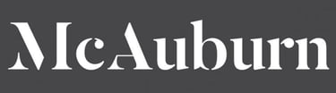 a black and white logo with the words,'McAuburn' '