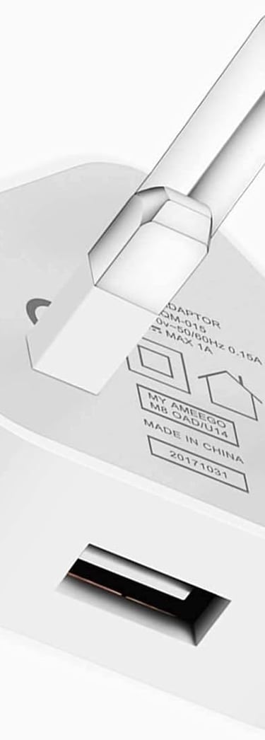 a white and silver colored power plugged in a white wall