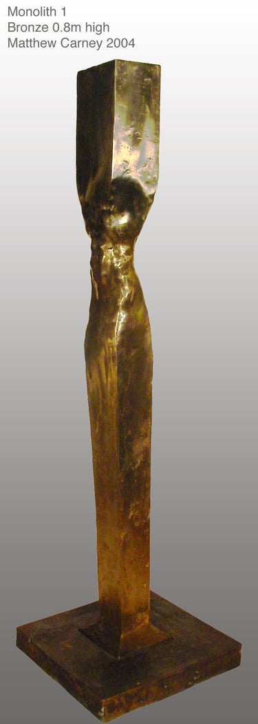 a bronze sculpture of a man's torso inside a column
