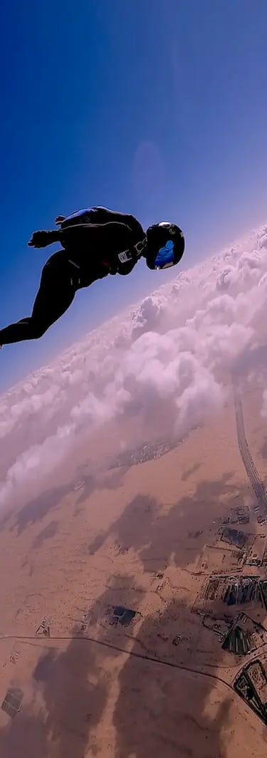 Mais Alhajri skydiving the desert with clouds in the background