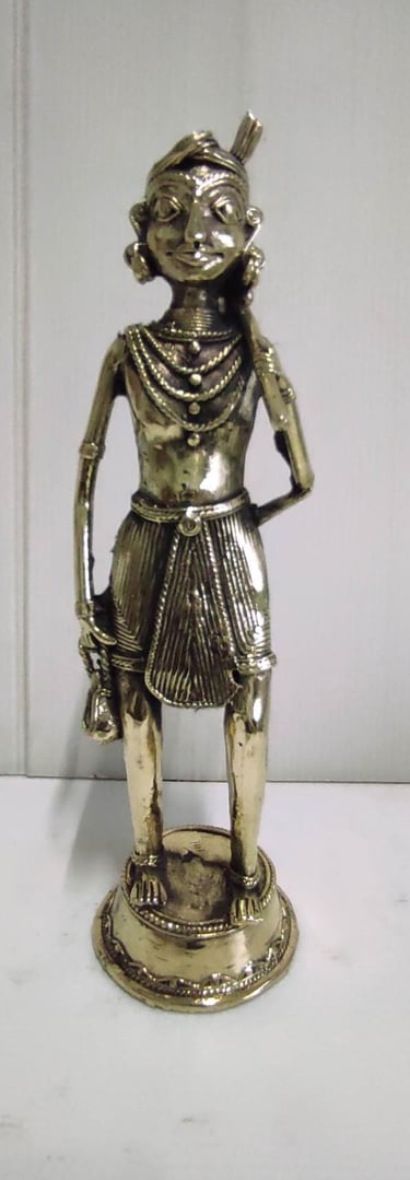 "Tribal farmer holding a plough in traditional attire–front view–handcrafted in brass-for export compliance