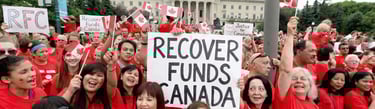 A group of people protesting and holding writings "Recover Funds Canada" "Crypto Recovery Canada"