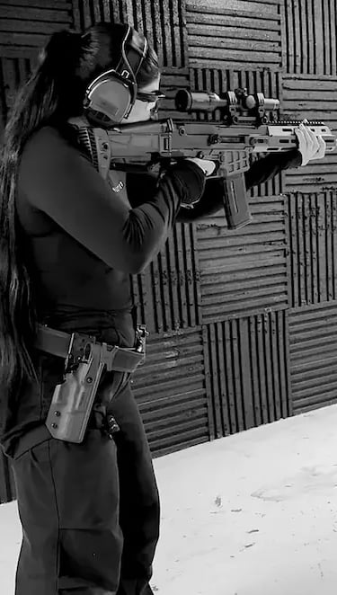 mais alhajri aiming with a rifle at a shooting range wearing safety gear
