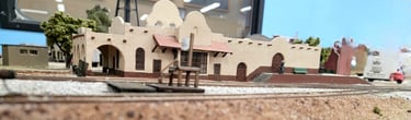 Gilbert Train Station in Gilbert, Arizona. Tan stucco building with curved arches along the roof.