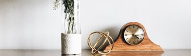 a vase with a clock and a vase with flowers
