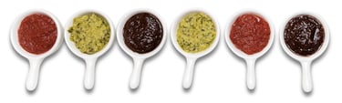 Sustainable plant-based sauces displayed in small white dishes