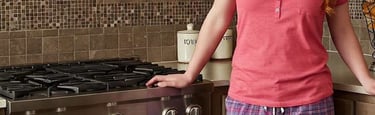attractive housewife in pajamas in kitchen