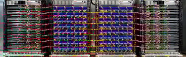 A high-performance data center server rack with organized fiber optic cables and networking hardware.