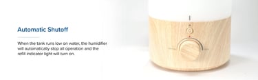 Wood-grain Levoit base close-up with indicator light on and knob pointing toward max