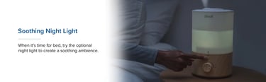 User pressing night light button on softly lit humidifier at bedtime