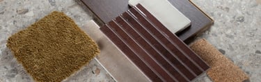 Interior design mood board featuring terrazzo tile, dark wood flooring, and olive green carpet samples.