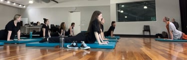 a group of people doing yoga exercises on their mats