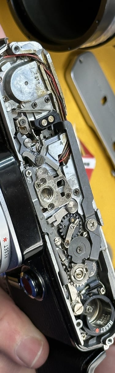 dismantled camera being inspected