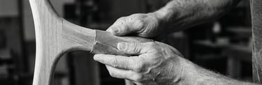 Hands of french craftman sanding an organic piece of wood