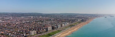 a beach with a view of the ocean and a city