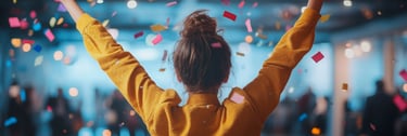 a woman with her arms up being showered in confetti